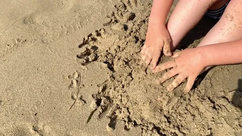 Happy child boy playing with sand on the seashore. Summer and travel concept Stock Footage 220432436