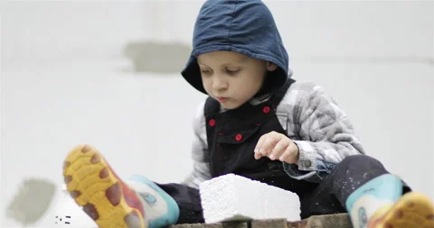 Happy child boy playing with tools on a construction site. Stock Footage 143698310