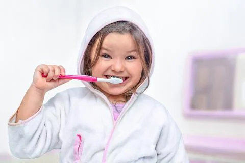 Happy child brushing teeth Stock Photos