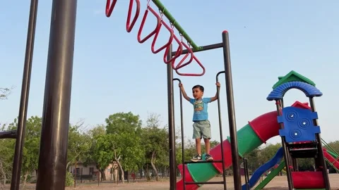 Happy Child Climbing Monkey Bars In Public Park Adventure Playground Activity Stock Footage 340958619