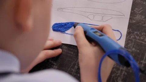 Happy child creating new 3d object with 3d printing pen.Robotics class for child Stock Footage 150670265