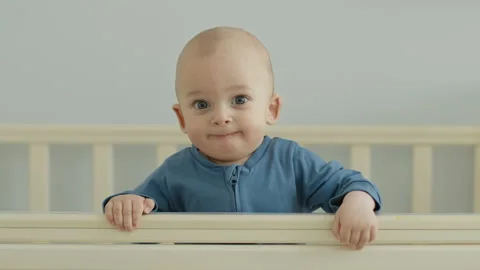 Happy child in a  crib Stock Footage 143360937