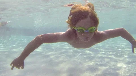 Happy child diving in a swimming pool Stock Footage 65214799