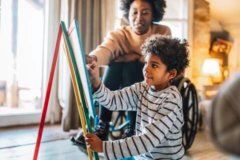 Happy child doing math exercises with her mother ot teacher together. Education Foto stock