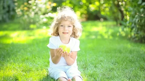 Happy child eating apple Stock Footage