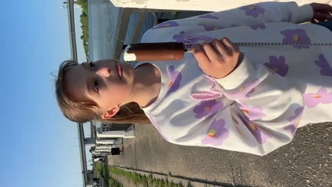 A happy child eats ice cream while relaxing in the park on a summer day, Stock Footage 242503698