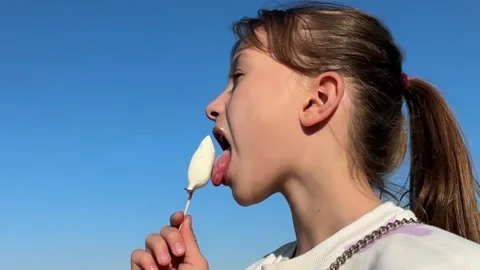 A happy child eats ice cream while relaxing in the park on a summer day, Stock Footage 242503743