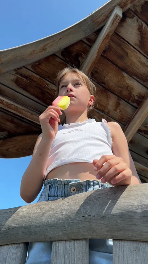 A happy child eats ice cream while relaxing in the park on a summer day, Stock Footage 244326452
