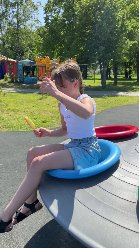 A happy child eats ice cream while relaxing in the park on a summer day, Stock Footage 244326561