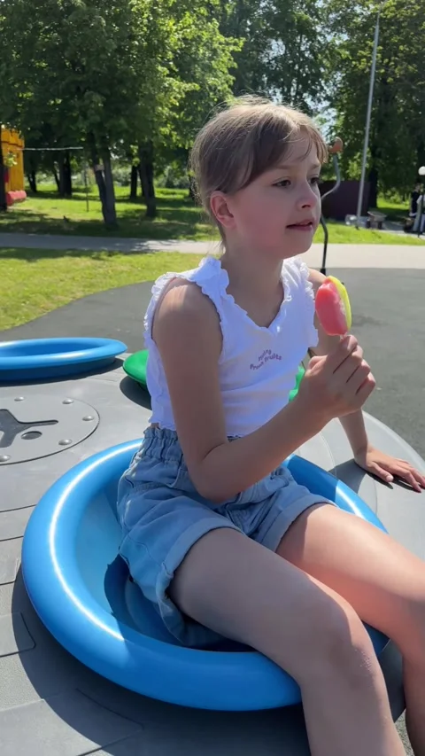 A happy child eats ice cream while relaxing in the park on a summer day, Stock Footage 244326627