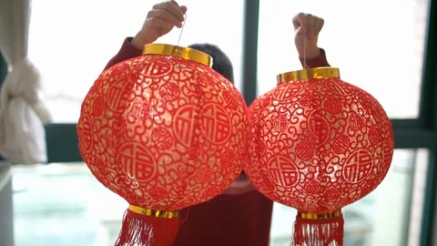 Happy child hanging the red lantern when Chinese new year at home Stock Footage 90485355