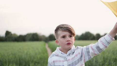Happy child having fun playing with paper airplane toy outdoor during travel Stock Footage 182588264