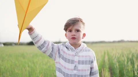 Happy child having fun playing with paper airplane toy outdoor Stock Footage 196998481