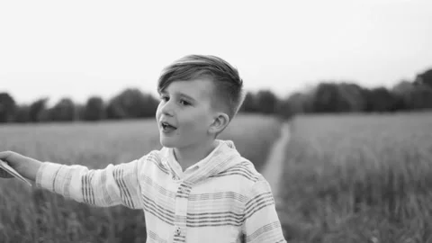 Happy child having fun playing with paper airplane toy outdoor 스톡 동영상 198219925