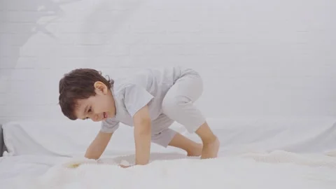 Happy Child Jumping Up and Down On The Bed and Have Fun Stock-Footage 244342361