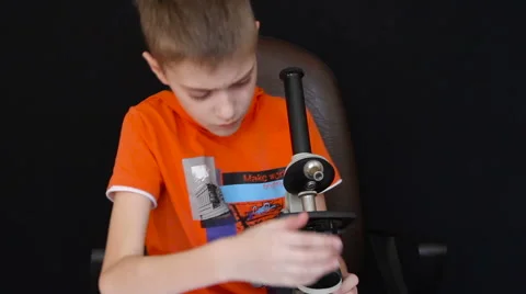 Happy Child Looks Through a Microscope Video stock 61605636
