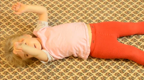 Happy Child Lying on a Carpet, Crazy Emotions Stock Footage 47163698