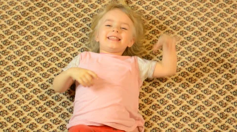 Happy Child Lying on a Carpet, Crazy Emotions Stock Footage 47163817