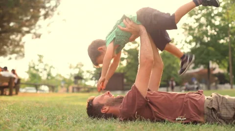 Happy child play with dad at sunset park summer outdoor 動画素材 64463566