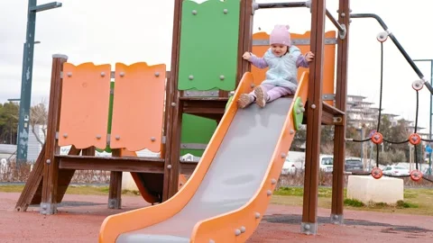 Happy child on the playground. Rolling down the hill Stock Footage 270232271