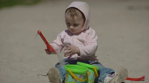 Happy child playing with sand at the beach in summer Stock Footage 62734119
