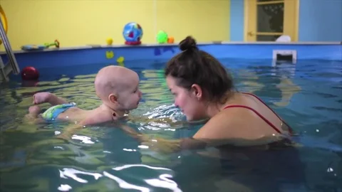 Happy. the child in the pool with the coach. Stock Footage 82256612