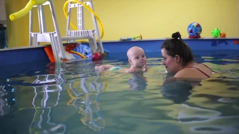 Happy. the child in the pool with the coach. Stock Footage 82256619