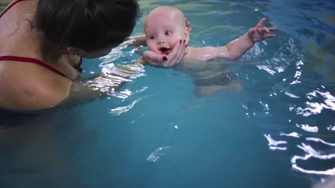 Happy. the child in the pool with the coach. Stock Footage 82256630