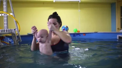 Happy. the child in the pool with the coach. Stock Footage 82256639
