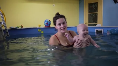 Happy. the child in the pool with the coach. Stock Footage 82256644