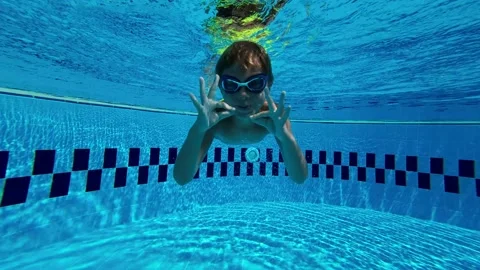 Happy Child Posing and Making Signs Underwater Stock Footage 196742143