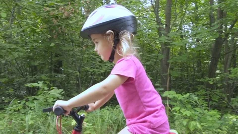 Happy child riding a bike in outdoor. Stock Footage