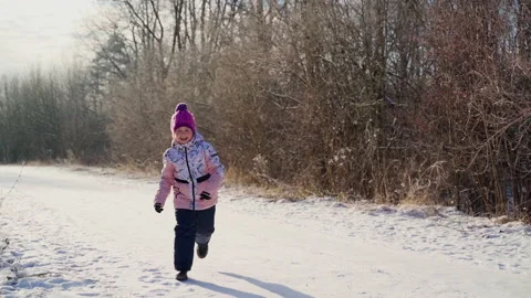 Happy child run looking at camera at winter woods outdoors Stock Footage 166989341