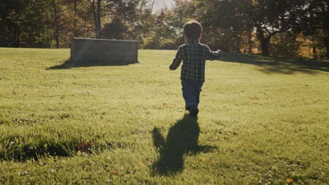 Happy child running in the park, active and healthy kid. Handheld shot Stock Footage 246757979