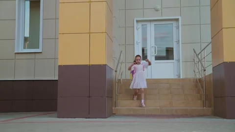 Happy child runs with school backpack up stairs. call lesson. learning little Stock Footage 247498613