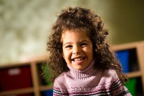 Happy child smiling for joy at camera in kindergarten Stock Photos