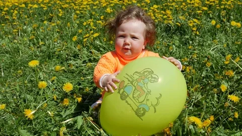 Happy child in a spring glade in dandelions with his family Stock Footage 76237596