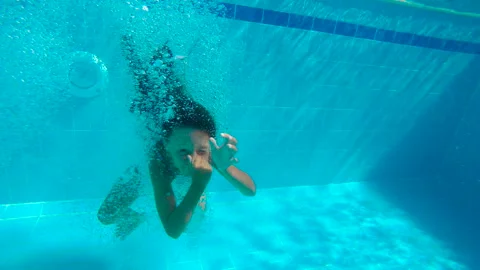Happy child in the summer pool. Stock Footage 241183155