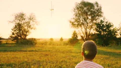Happy child throws toy plane with his hand on field, sunset. Kid aviator. Boy 스톡 동영상 249125876