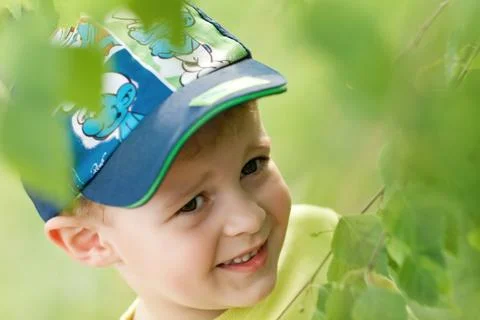 Happy child under tree branches Stock Photos