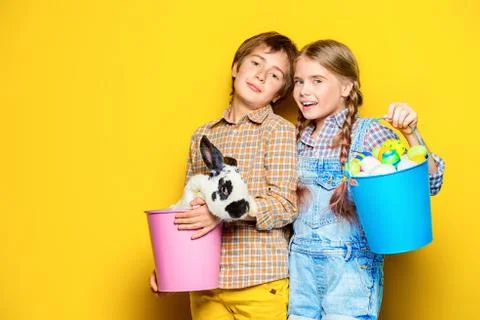 Happy children are posing with Easter attributes on blue  background. Happy c Stock Photos