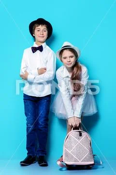 Happy children are posing in elegant clothes on blue background. Happy child Stock Photos