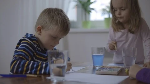 Happy children - boy and two girls is drawing with colorful paint Stock Footage 101631603