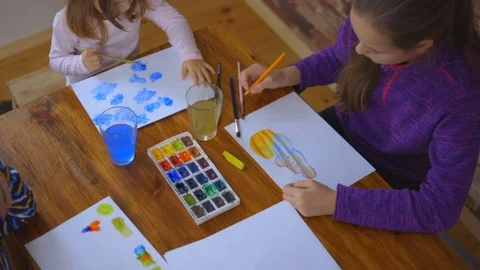 Happy children - boy and two girls is drawing with colorful paint Stock Footage 101631654