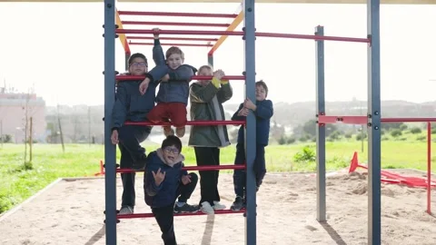 Happy children climbing on playground monkey bars Stock Footage 327760334