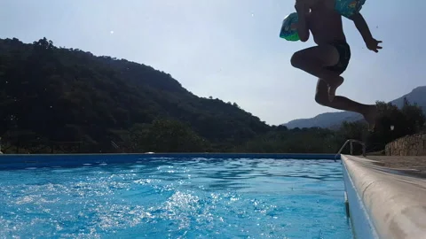 Happy children dive into the pool Stock Footage 132192505