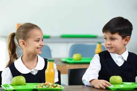 Children with healthy food at school canteen Stock Photo