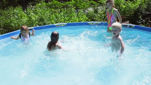 Happy children having fun in a pool splashing water slowmo 스톡 동영상 200897179