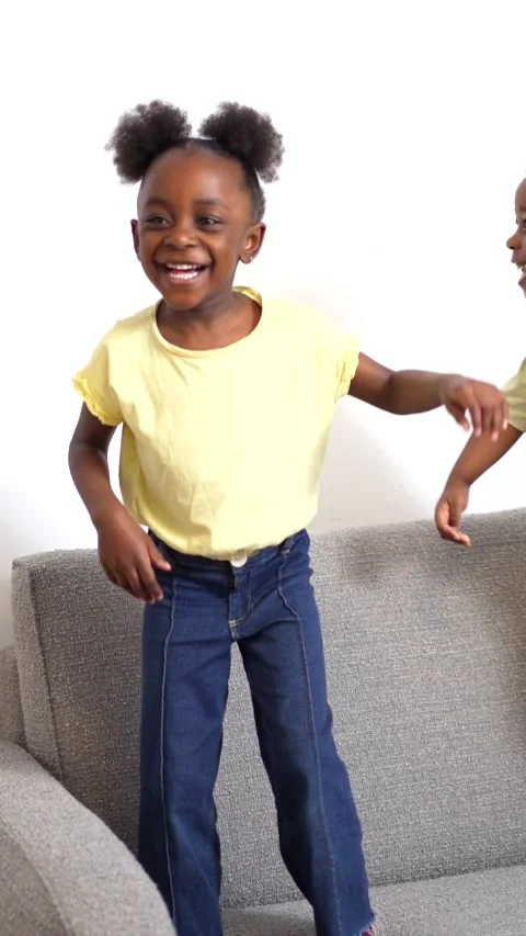 Happy children jumping and dancing on sofa Stock Footage 313012146