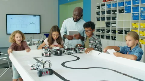 Happy Children Launching Robot Models at Kids Tech Club Vídeos de archivo 244349719